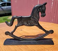 Side profile of black cast iron rocking-horse doorstop