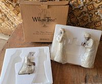 Outer cardboard box and two Styrofoam trays showing figures