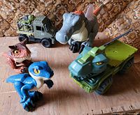 Group shot of all dinosaur figures and vehicles