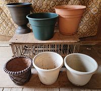 All six assorted plastic planters displayed together