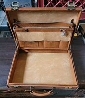 Briefcase open showing interior compartments and keys
