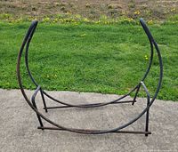 front view of arched tubular metal firewood rack