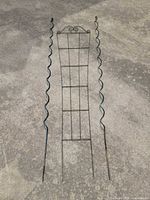 Full view of trellis and both spiral stakes laid on concrete