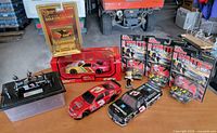 Full lot overview showing all die-cast cars, display chassis and figurine