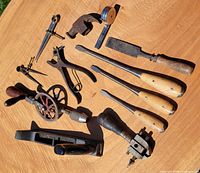 Group of all tools laid out on tabletop showing variety and condition