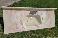 Front view of vanity top showing basin, backsplash and faucet