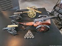 Top view of all four miniature cannons and cannonball pyramid
