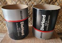 Front view of both cylindrical Sears DieHard battery display containers
