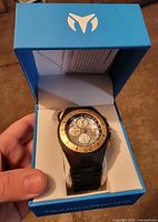 Watch in open TechnoMarine box showing dial and bezel