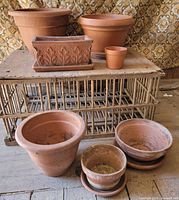 Group shot showing all pots and planters on and in front of wicker stand