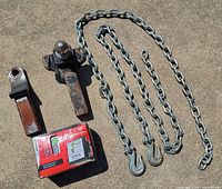 All items overview: two hitch mounts, boxed breakaway kit, three chains