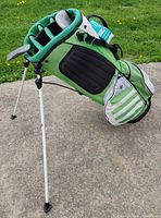 Full side view of green Adidas stand golf bag on extended legs