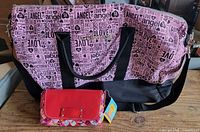 Front view of duffle bag with clutch placed in front showing scale and exterior graphics