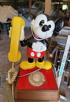 Front view of Mickey Mouse telephone showing handset, figure, and rotary dial