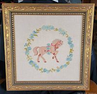 Front view of framed embroidery showing entire design and frame