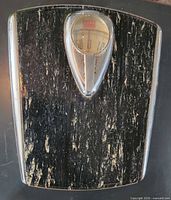 Top view of scale showing black speckled platform and chrome fish-eye dial