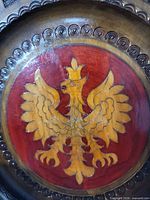 Front view showing carved eagle motif and rim decoration