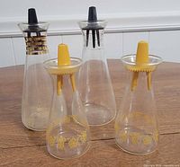 Group of four Pyrex glass shakers/cruets