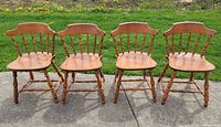Four matching S. Bent & Bros colonial low-back chairs on outdoor surface