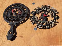 Both cast iron Amish trivets side by side