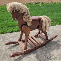 Side view of full wooden rocking horse