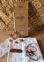 Box, styrofoam insert, metal star backdrop, corded light visible