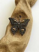 Front view of butterfly brooch showing design details