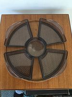 Top view showing teak base and five plastic dishes assembled