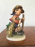 Front view of Goebel Hummel On Secret Path figurine showing boy and details