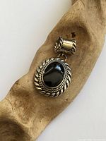 Front view of sterling silver pendant with black onyx