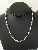 Full view of beaded necklace on display form