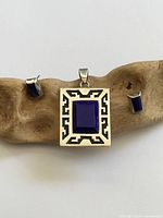 front view of pendant and earrings displaying design and gemstone
