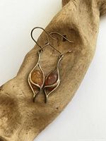 Front view of both earrings displaying amber stones and sterling frames