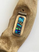 Front view of sterling silver pendant on wood prop