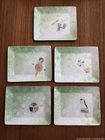 Five rectangular enamel dishes laid out together