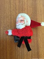 Front view of Santa ornament showing face, beard and suit