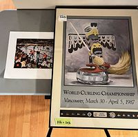 Framed World Curling Championship poster next to loose curling print
