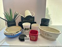 Group shot of all planters, bowl, watering can, artificial plant