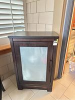 Front view of espresso MDF cabinet showing frosted glass door and bar handle