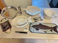 Full view of all platters, bowls, forks, knife on table