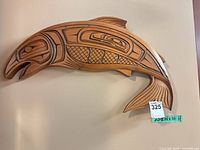 Full view of carved wood fish wall plaque