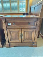 Nightstand front view closed showing drawer and doors