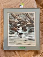Framed lithograph showing ducks on water with mats and frame