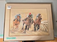 Full view of framed print showing three racing horses and jockeys