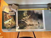 overview of art print, placemats, napkins, napkin rings on table