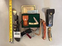 Group view showing all five knives, sheaths, box, certificate, sharpening stone and measuring tape for scale