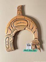 Front view of carved wooden Indigenous-style wall art showing overall design and finish