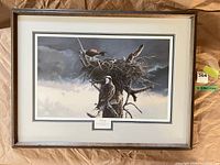 Framed signed print showing ospreys on nest in wood frame with mat
