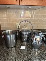 Three vessels: wine cooler bucket, chrome ice bucket with handle, thermal carafe
