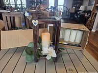 assembled centerpiece showing wood frame, floral trim and LED candle